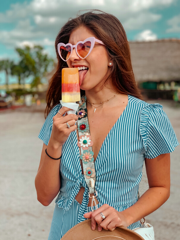 Woman Eating Popsicle on Beach